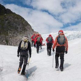 a group of people standing on top of a snow covered slope