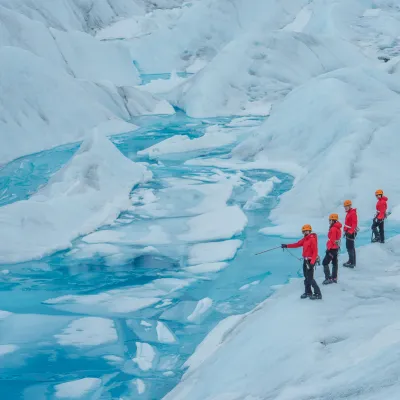 a group of people riding skis on top of a snow covered slope
