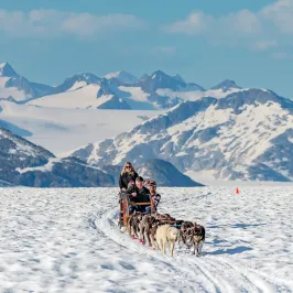 a person sitting on top of a snow covered mountain