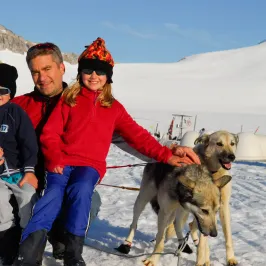 a person holding a dog in the snow