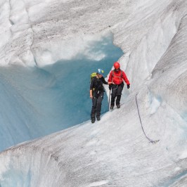 a man riding skis down a snow covered slope