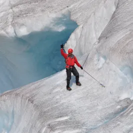 a man riding skis down a snow covered slope