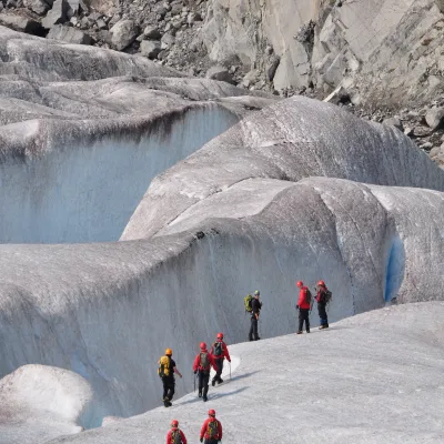 a group of people walking across a snow covered mountain