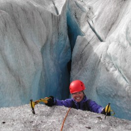 a man standing on a rock in the snow