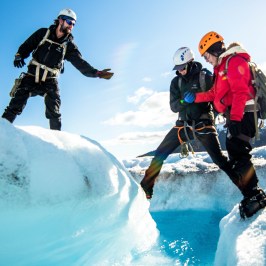 a man riding a snowboard down a snow covered slope