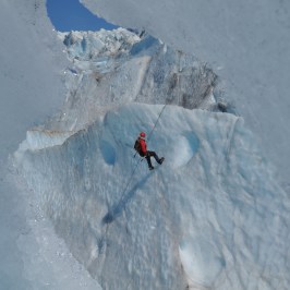 a man riding skis down a snow covered mountain
