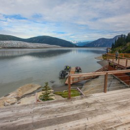 a wooden bench next to a body of water