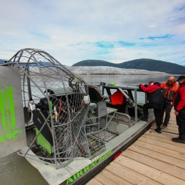 a group of people sitting at a dock