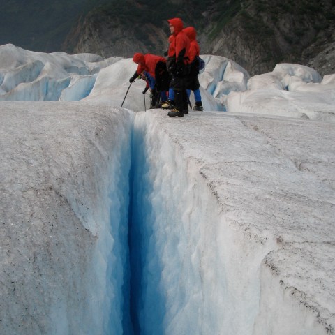 a man riding on top of a snow covered mountain