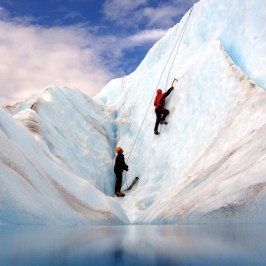 a man riding skis down a snow covered mountain