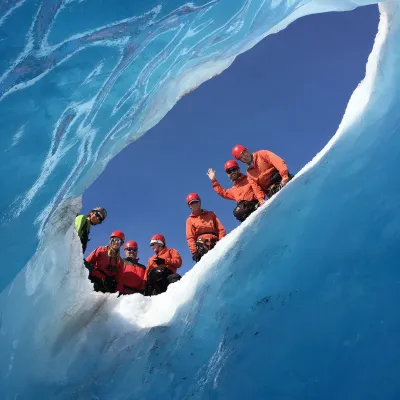 a group of people riding skis on a snowy mountain