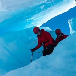 a man standing on top of a snow covered mountain