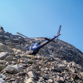 a man flying through the air on a rocky hill