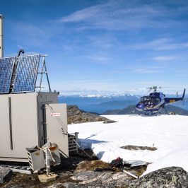 a helicopter and a building on a mountain