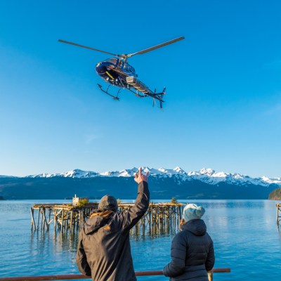 a person standing next to a body of water