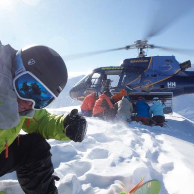 a man riding a snowboard down a snow covered slope