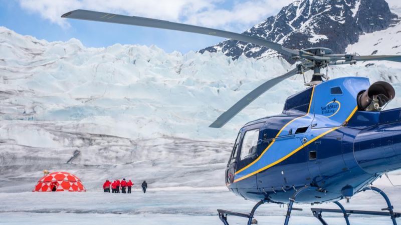 a plane sitting on top of a snow covered mountain